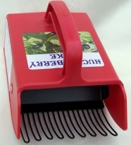 Red berry picker tool with curved metal tines for harvesting.