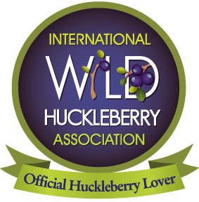 Logo of the International Wild Huckleberry Association with a green ribbon.