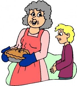 An elderly woman offers a pie to a child in a kitchen.