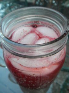 Cold berry drink in a glass jar.