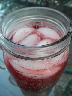 Cold berry drink in a glass jar.