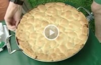 A large pie with a golden, puffy crust.