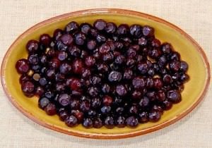 Bowl of dark berries on a table.