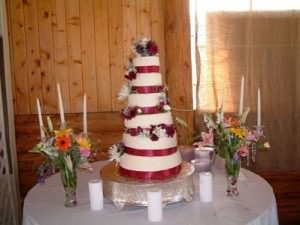 Tiered wedding cake with flower decorations.