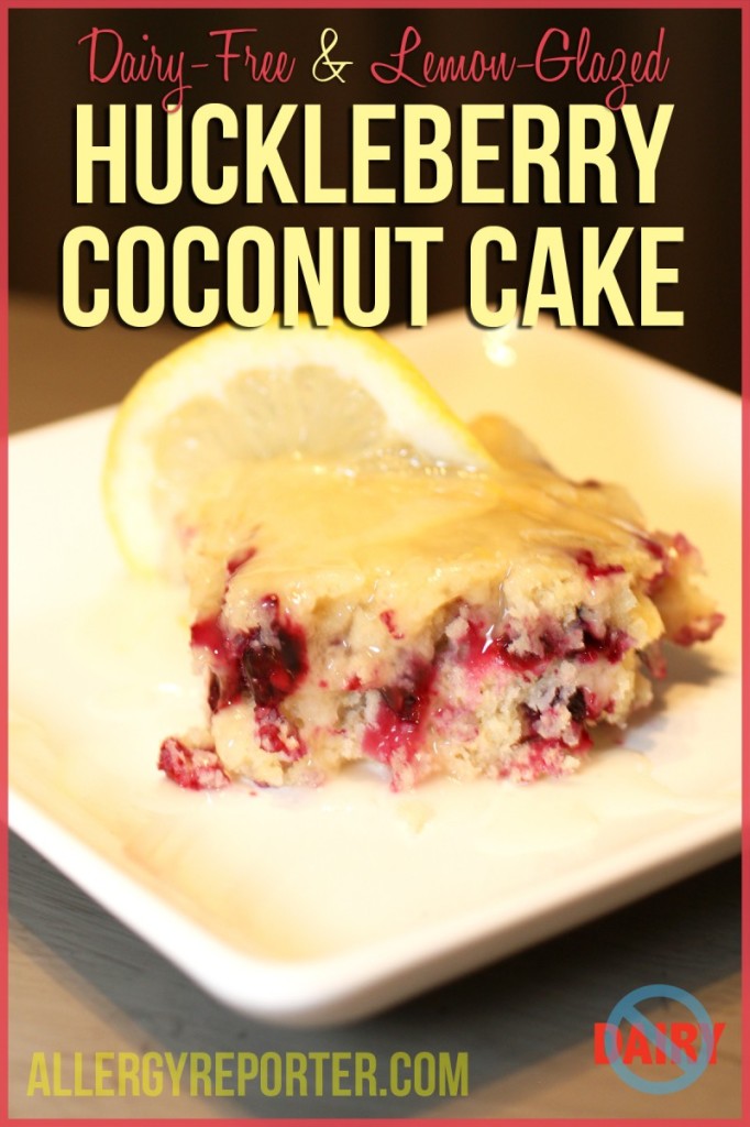 A slice of raspberry coconut cake with creamy frosting on a white plate.