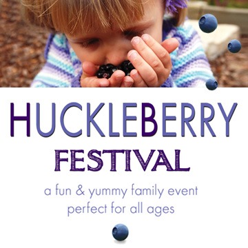 A child enjoying fresh huckleberries at the Huckleberry Festival.