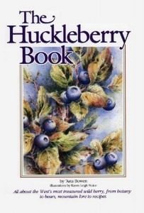 Close-up of ripe blueberries growing on leafy bushes.