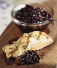 Grilled sandwich with blueberry jam on a wooden board.