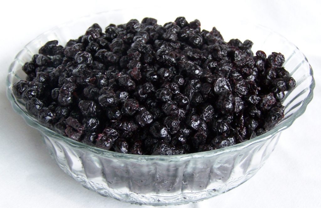 A bowl filled with dried black currants.