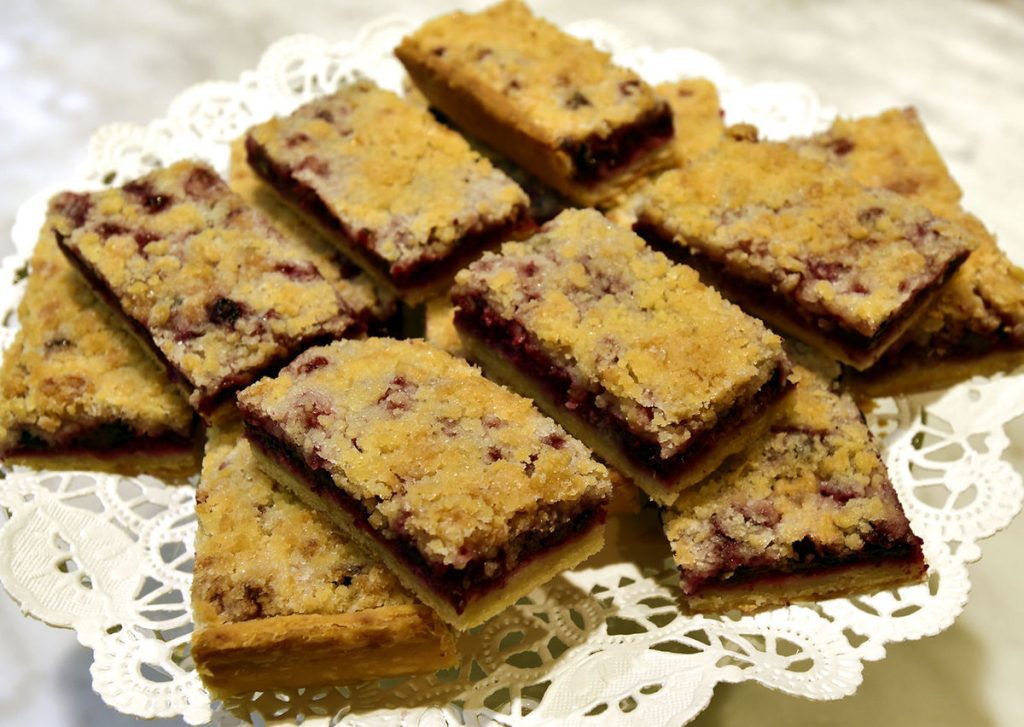 Delicious chocolate chip cookie bars neatly cut and arranged on a lace doily.