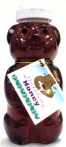 Bear-shaped honey bottle with label.