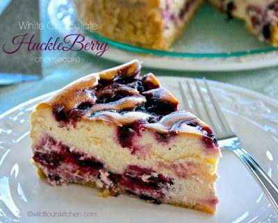 A slice of creamy berry cheesecake with a graham cracker crust.