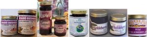 Two jars of buckwheat honey and buckwheat jam on a table.