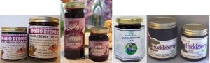 Three jars of blueberry jam with different labels and designs.