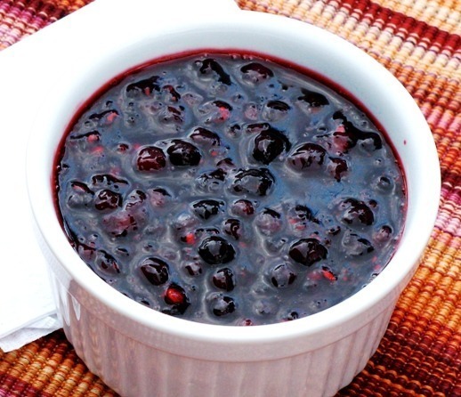 A bowl of fresh blueberry sauce with whole berries.