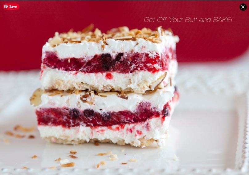 Layered dessert with cream and berry filling topped with nuts.