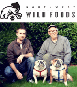 Two men with bulldogs in garden.